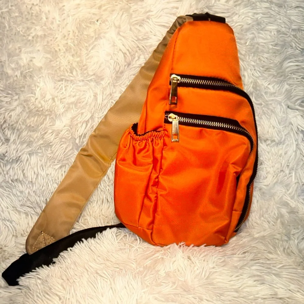 Orange body cross bag with a gold zippers. NEVER WORN - Picture 1 of 4
